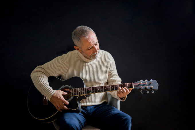 seniors learn to play the guitar